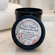 Jar of sugar scrub with a label on a cluttered background