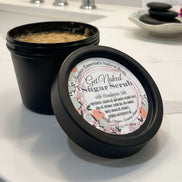 Jar of natural body scrub with visible contents and label.