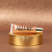 Lip gloss tube with 'Allure' branding on a marbled surface