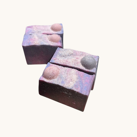 Creation Essential's Natural Body Moon Light salty soap bars with purple and pink swirls and Himalayan salt topping.