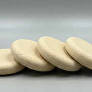 Stack of soap bar  on a wooden board with a blurred background