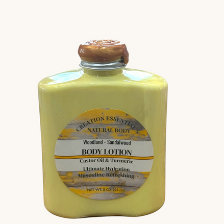 Creation Essential's Natural Body Woodland Sandalwood men's body lotion in a yellow bottle with a wax-sealed cap.
