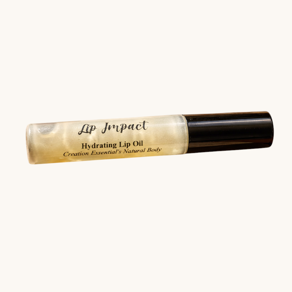 Lip impact hydrating lip oil on crumpled brown paper with a leaf