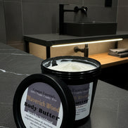 Body butter container with label on a marble countertop