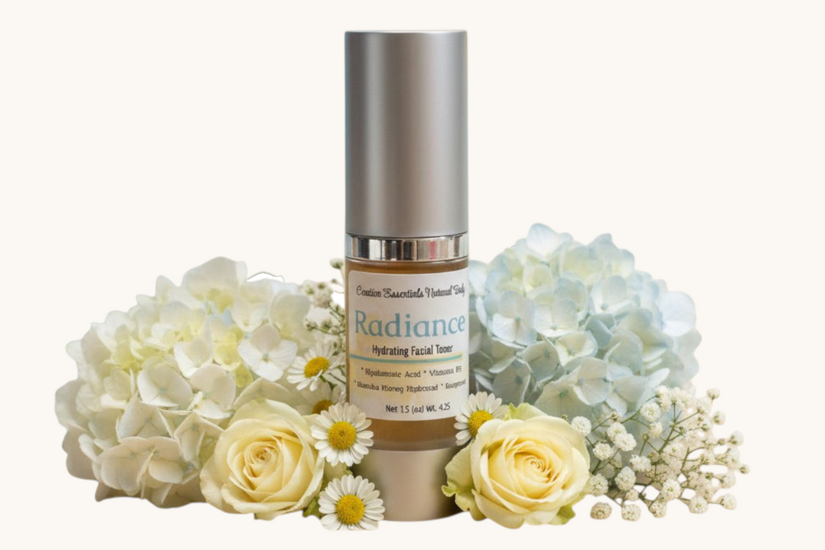 Creation Essential's Natural Body Radiance Hyaluronic Facial Toner bottle surrounded by white hydrangeas and roses.