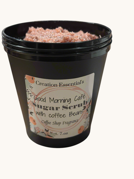 Creation Essential's Good Morning Cafe creamy body scrub with coffee beans and organic sugar in a black jar