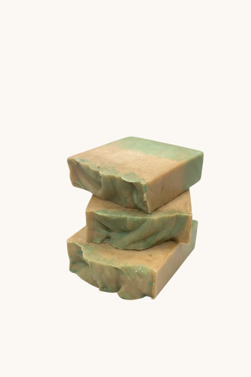 Creation Essential's Natural Body cucumber and melon hydration soap bar stack with green and tan marbled texture