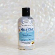 Shea Girl body lotion bottle with a white pearl blurred background