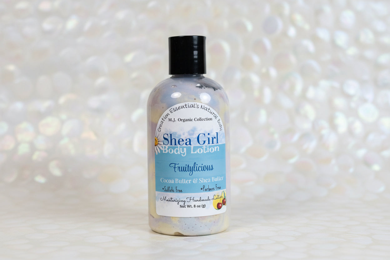 Shea Girl body lotion bottle with a white pearl blurred background