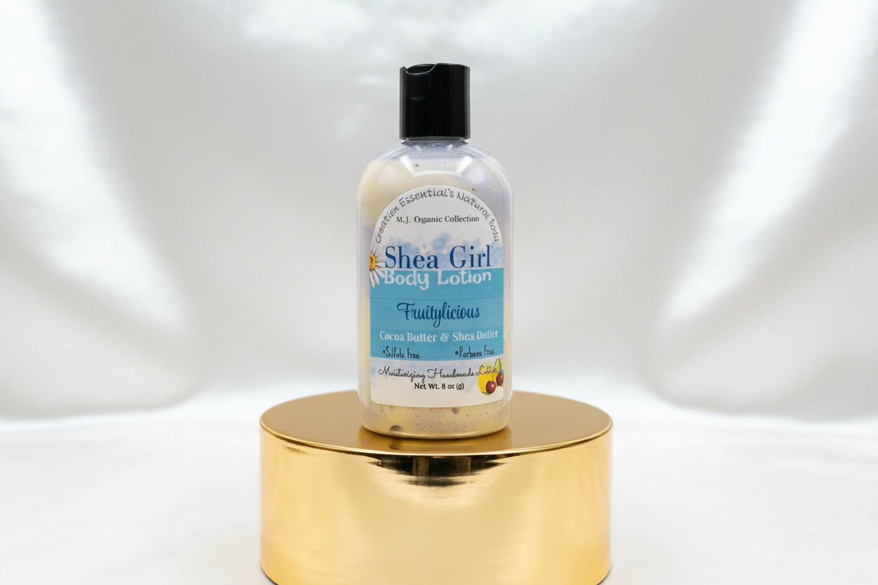 Bottle of Shea Girl body lotion on a wooden surface with a blurred background