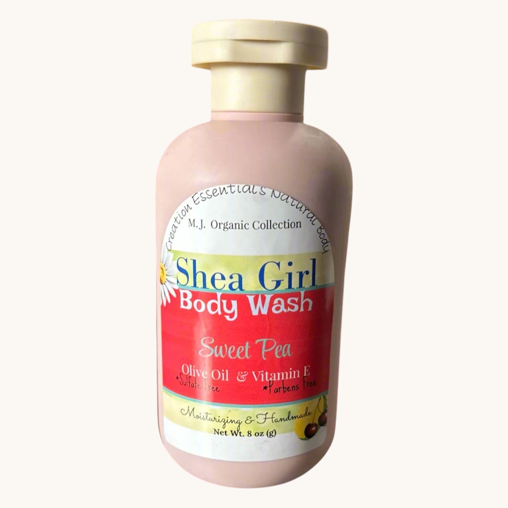 Creation Essential's Natural Body Shea Girl Sweet Pea body wash in a pink bottle on a bathroom vanity.