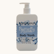 Butterfly Kisses body wash bottle on a bathroom counter with a blurred background