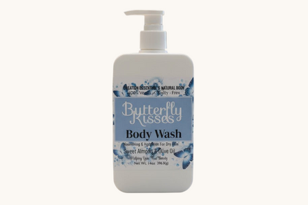 Butterfly Kisses body wash bottle on a bathroom counter with a blurred background