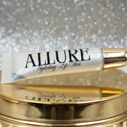 Allure lip balm tube on a beige background