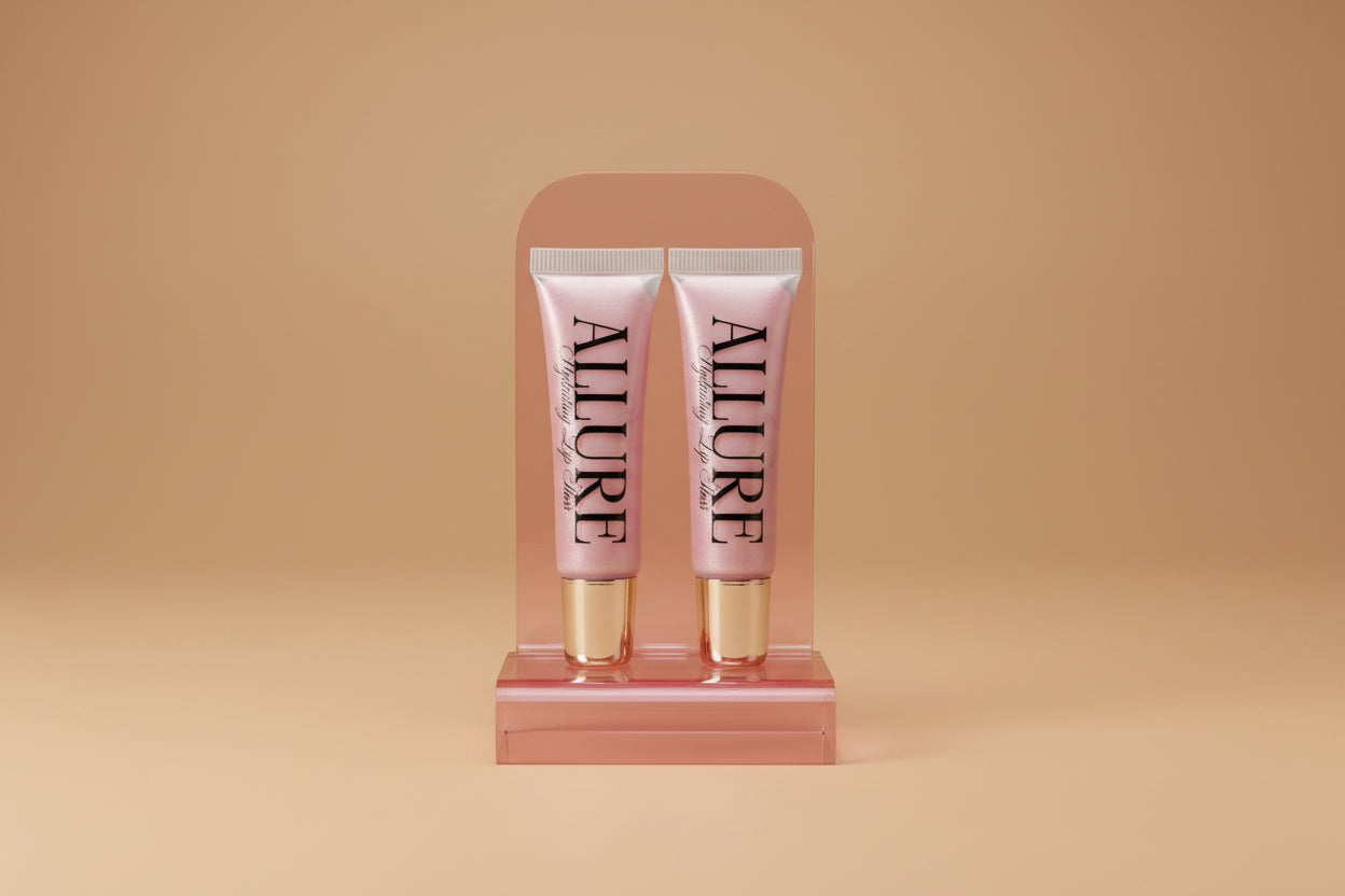 Two Allure lip gloss tubes on a marble surface