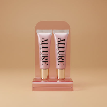 Two Allure lip gloss tubes on a marble surface