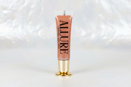 Lip gloss with 'ALLURE' branding on a marble surface