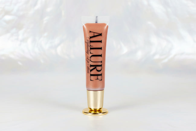 Lip gloss with 'ALLURE' branding on a marble surface