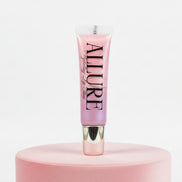 Pink lip gloss tube with 'Allure' branding on a pink stand against a white background