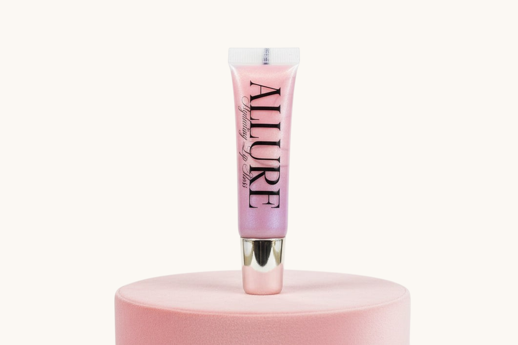 Pink lip gloss tube with 'Allure' branding on a pink stand against a white background