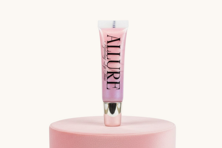 Pink lip gloss tube with 'Allure' branding on a pink stand against a white background