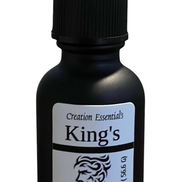 Creation Essential's Natural Body King's Beard Oil in a matte black dropper bottle with mahogany teakwood scent