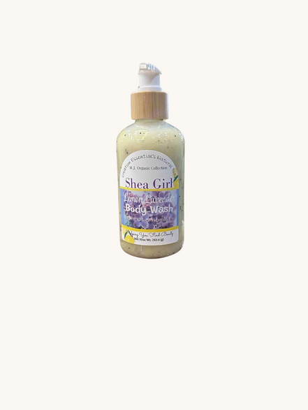 Creation Essential's Natural Body Shea Girl Lemon Lavender body wash in a clear pump bottle on a bathroom ledge.